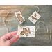 This shows three birch bark accent tags with fall leaf artwork burned onto the bark. Each tag has a piece of twine tied to it. 